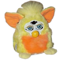 orange and yellow furby. his eyes glitter with malice
